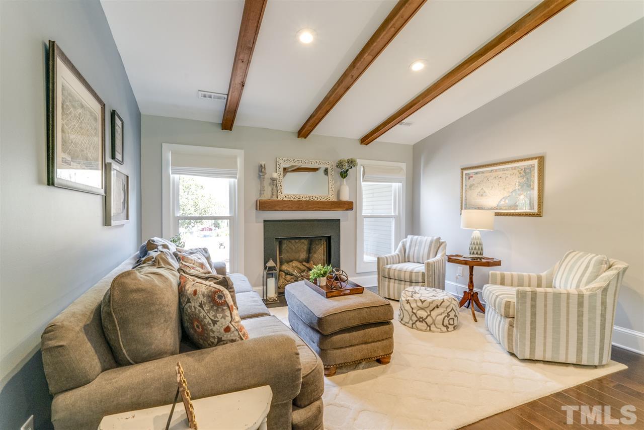 3105 Chancery Place Raleigh, NC 27607 - Photo 6 of 25 a living room with furniture fireplace and a large window
