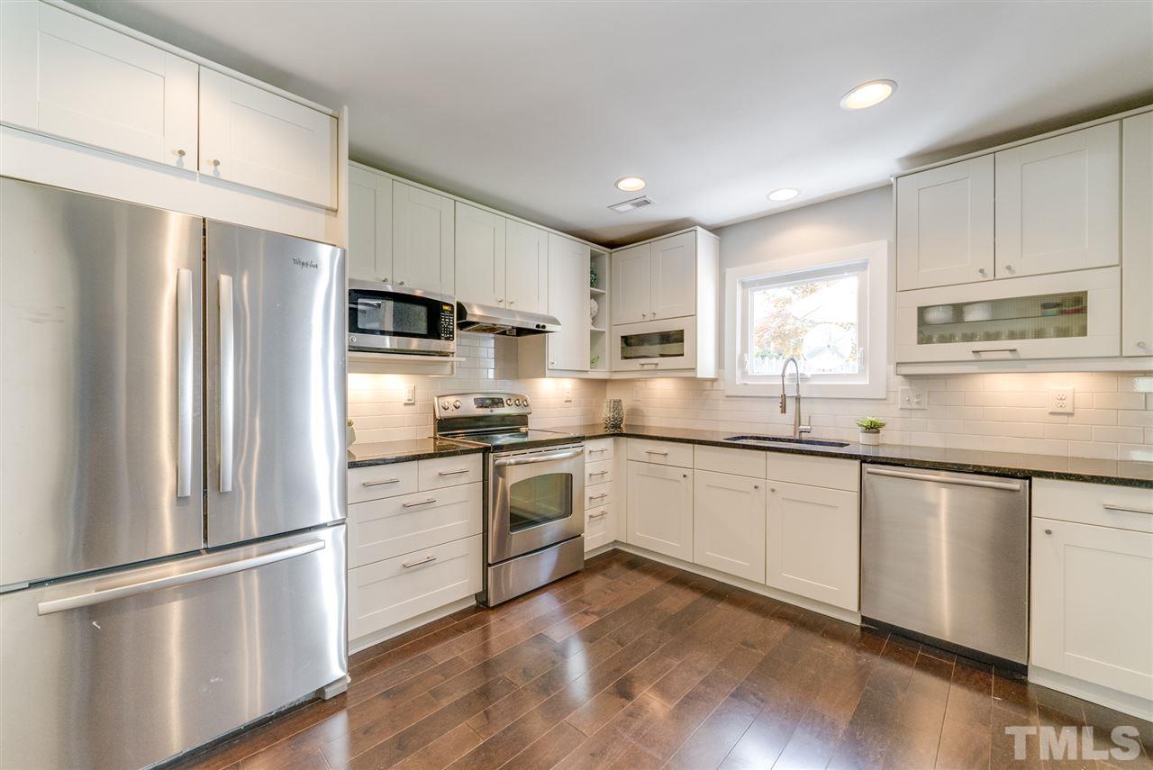 3105 Chancery Place Raleigh, NC 27607 - Photo 8 of 25 a kitchen with granite countertop white cabinets and white stainless steel appliances