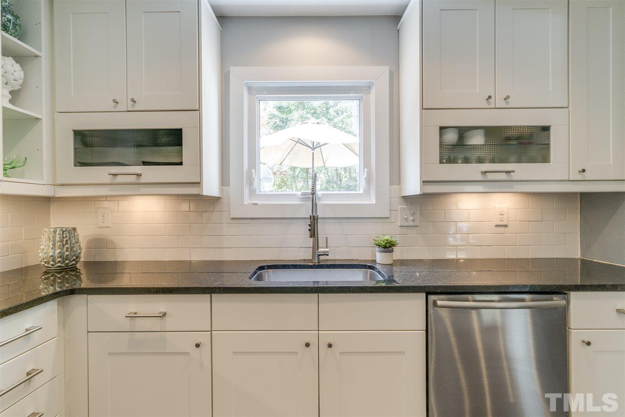 3105 Chancery Place Raleigh, NC 27607 - Photo 9 of 25 a kitchen with stainless steel appliances granite countertop white cabinets a window and a sink