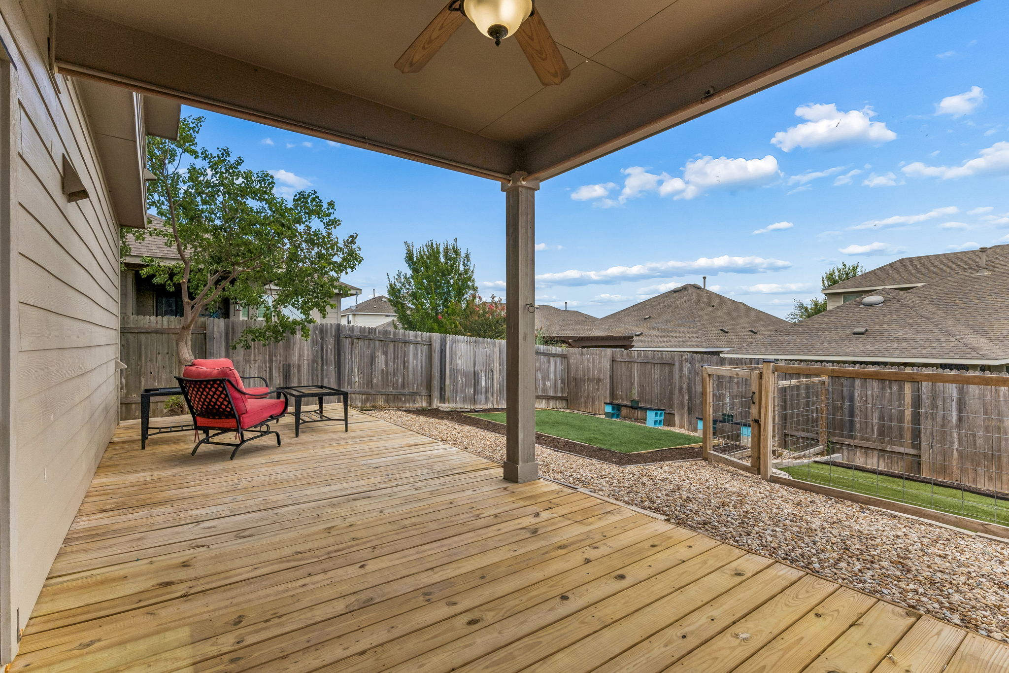 689 Nautical Loop Kyle, TX 78640 - Photo 34 of 34 A spacious wood deck extends to a fenced yard, perfect for outdoor relaxation and entertaining.