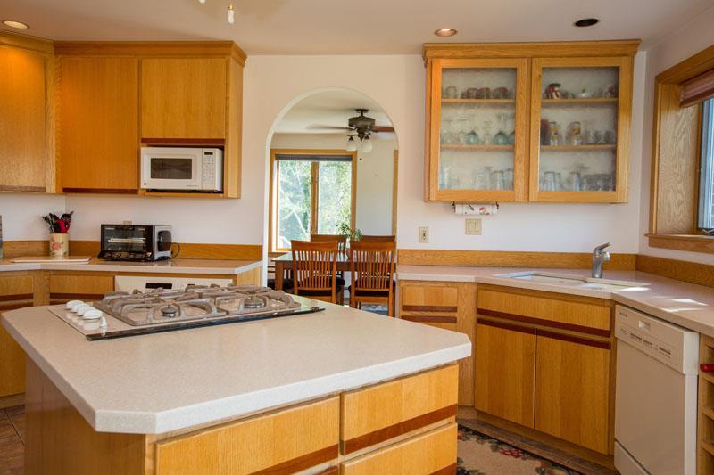 128 Longwoods Road Cumberland Center, ME 04021 - Photo 12 of 35 Corian countertops and gas cooktop.