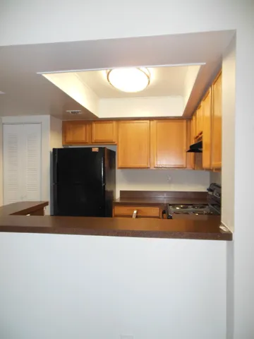 a kitchen with a sink a refrigerator and window