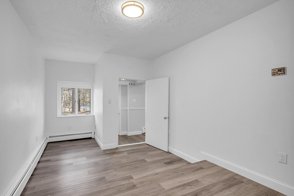 35 Gould Road Andover, MA 01810 - Photo 31 of 37 an empty room with wooden floor and windows