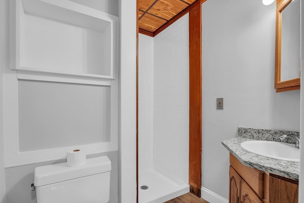 35 Gould Road Andover, MA 01810 - Photo 32 of 37 a bathroom with a granite countertop sink and a mirror