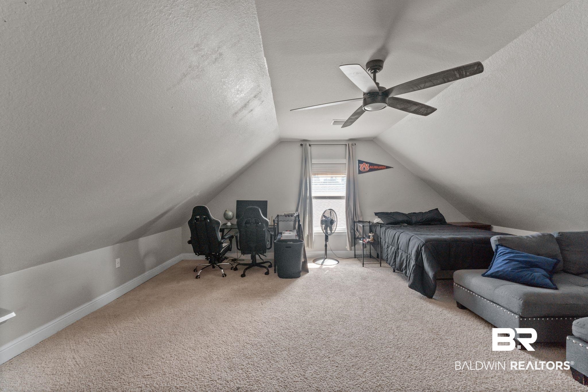 12711 Chickadee Lane Daphne, AL 36527 - Photo 25 of 39 Carpeted bedroom with a textured ceiling, lofted ceiling, and ceiling fan