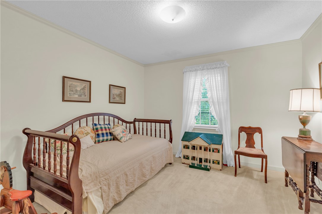 203 Fox Creek Road Anderson, SC 29621 - Photo 20 of 36 This cozy bedroom features plush carpeting and a bright window, creating a serene and inviting atmosphere.