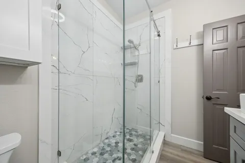 a bedroom with a bed and a chandelier