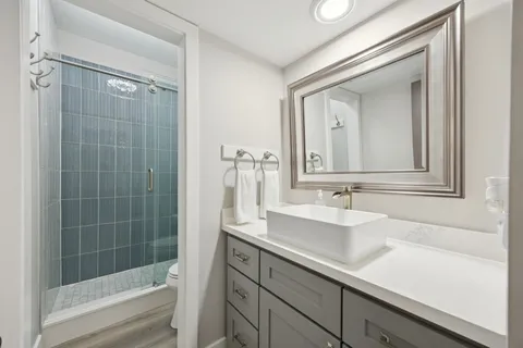 a bathroom with a shower a toilet and a sink