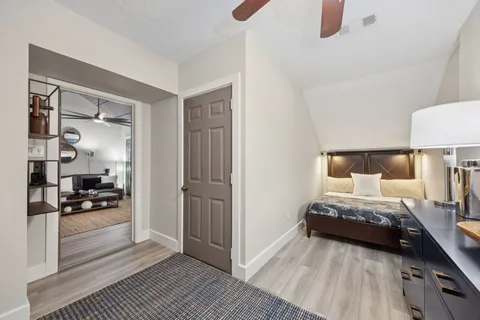 a bedroom with a bed and a television on dresser