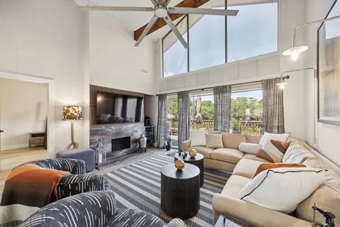 a living room with furniture a flat screen tv and a fireplace