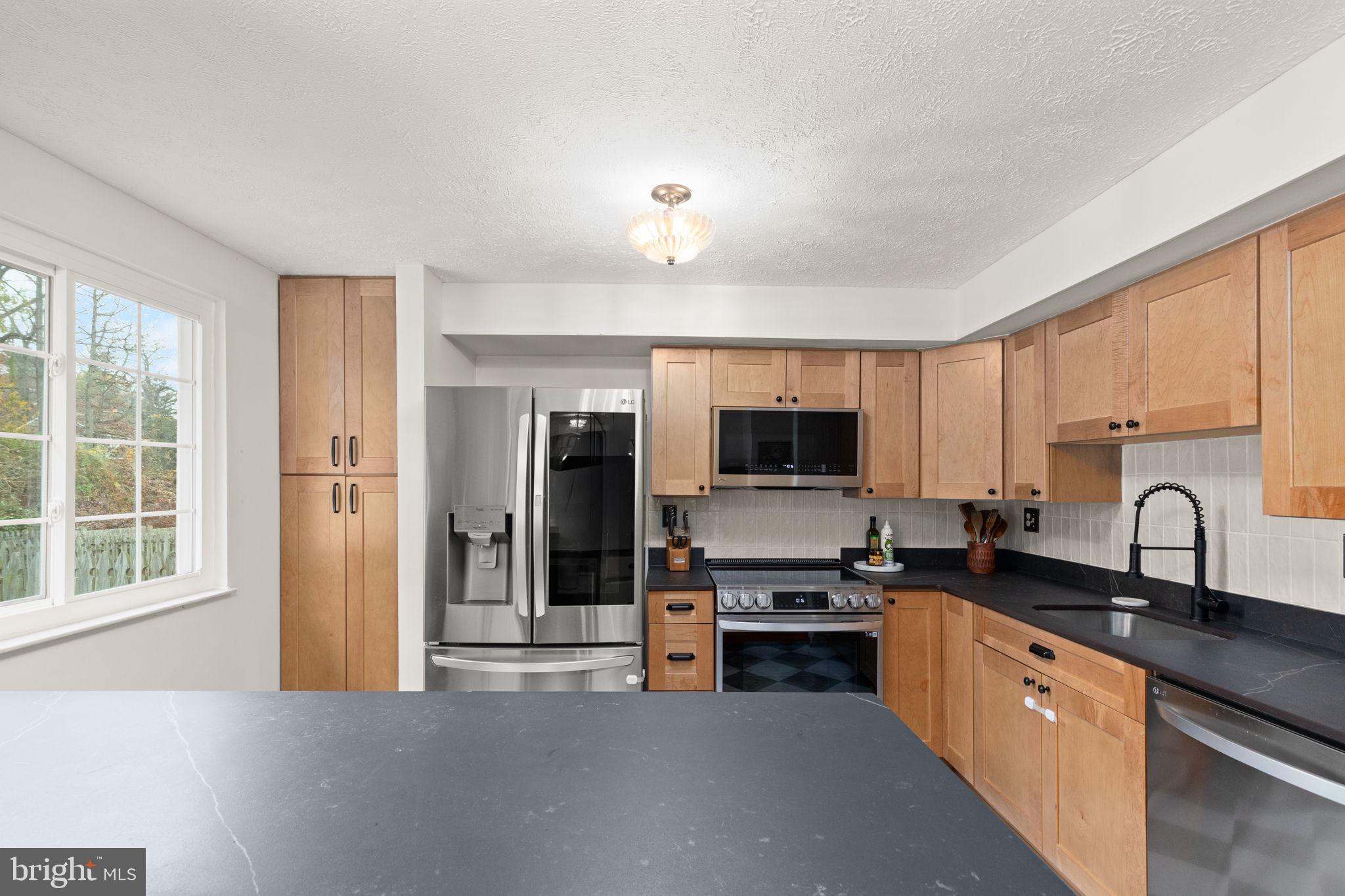 2530 Merrick Court Abingdon, MD 21009 - Photo 5 of 23 a large kitchen with stainless steel appliances granite countertop a stove a sink and a refrigerator