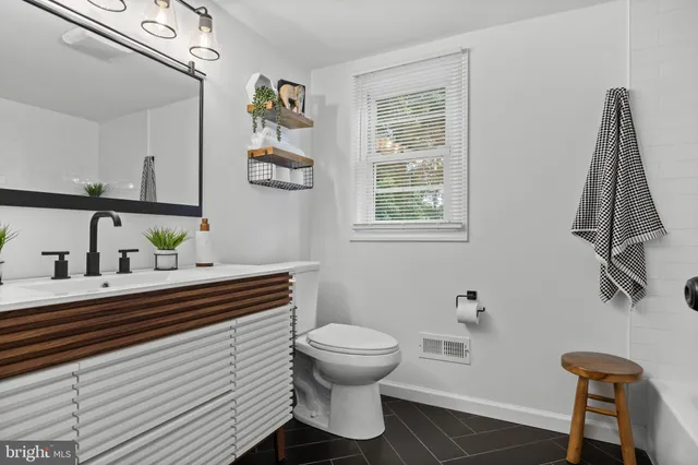 a bathroom with a sink a mirror and a toilet