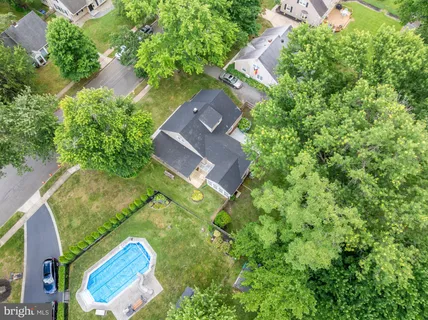 an aerial view of a house with a yard