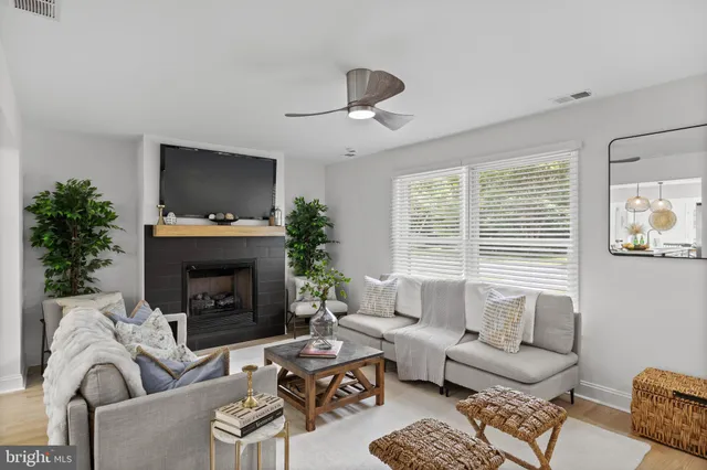 a living room with furniture a flat screen tv and a fireplace
