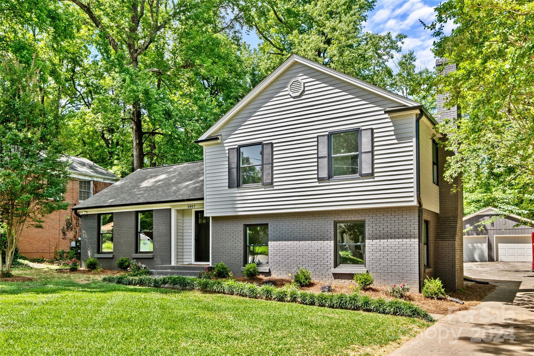 5807 Ruth Drive Charlotte, NC 28215 - Photo 1 of 41 a front view of a house with a yard and trees