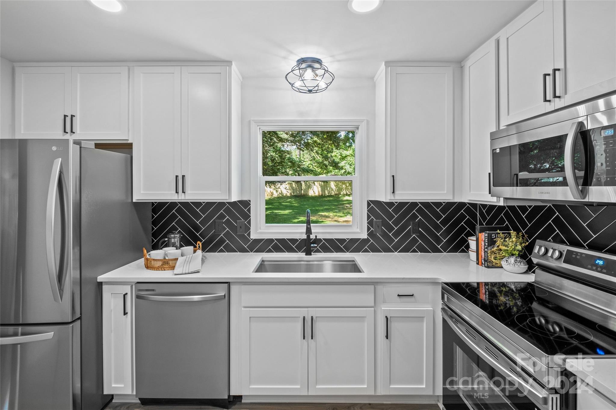 5807 Ruth Drive Charlotte, NC 28215 - Photo 12 of 41 a kitchen with stainless steel appliances granite countertop a sink stove and refrigerator