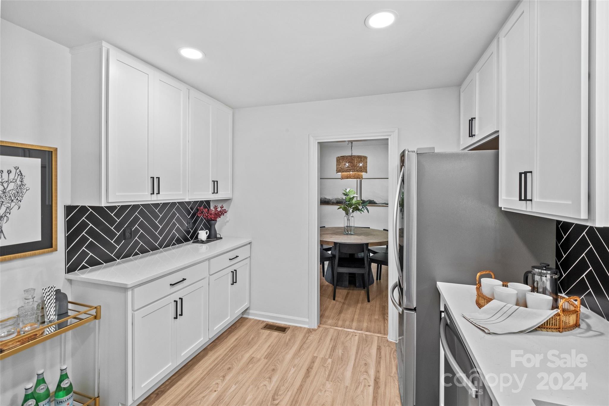 5807 Ruth Drive Charlotte, NC 28215 - Photo 13 of 41 a kitchen with granite countertop a refrigerator and a stove top oven