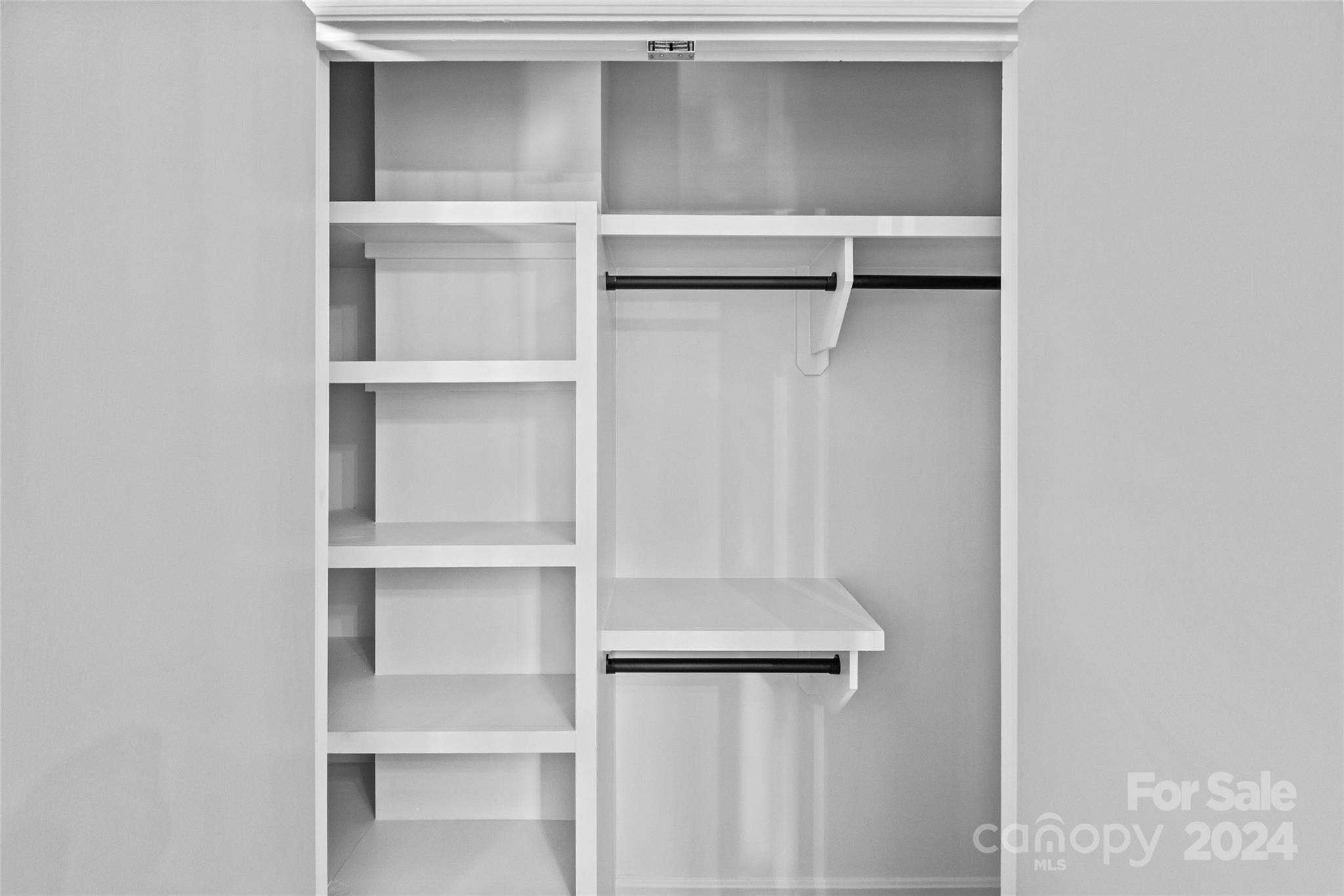 5807 Ruth Drive Charlotte, NC 28215 - Photo 19 of 41 a view of walk in closet with empty racks