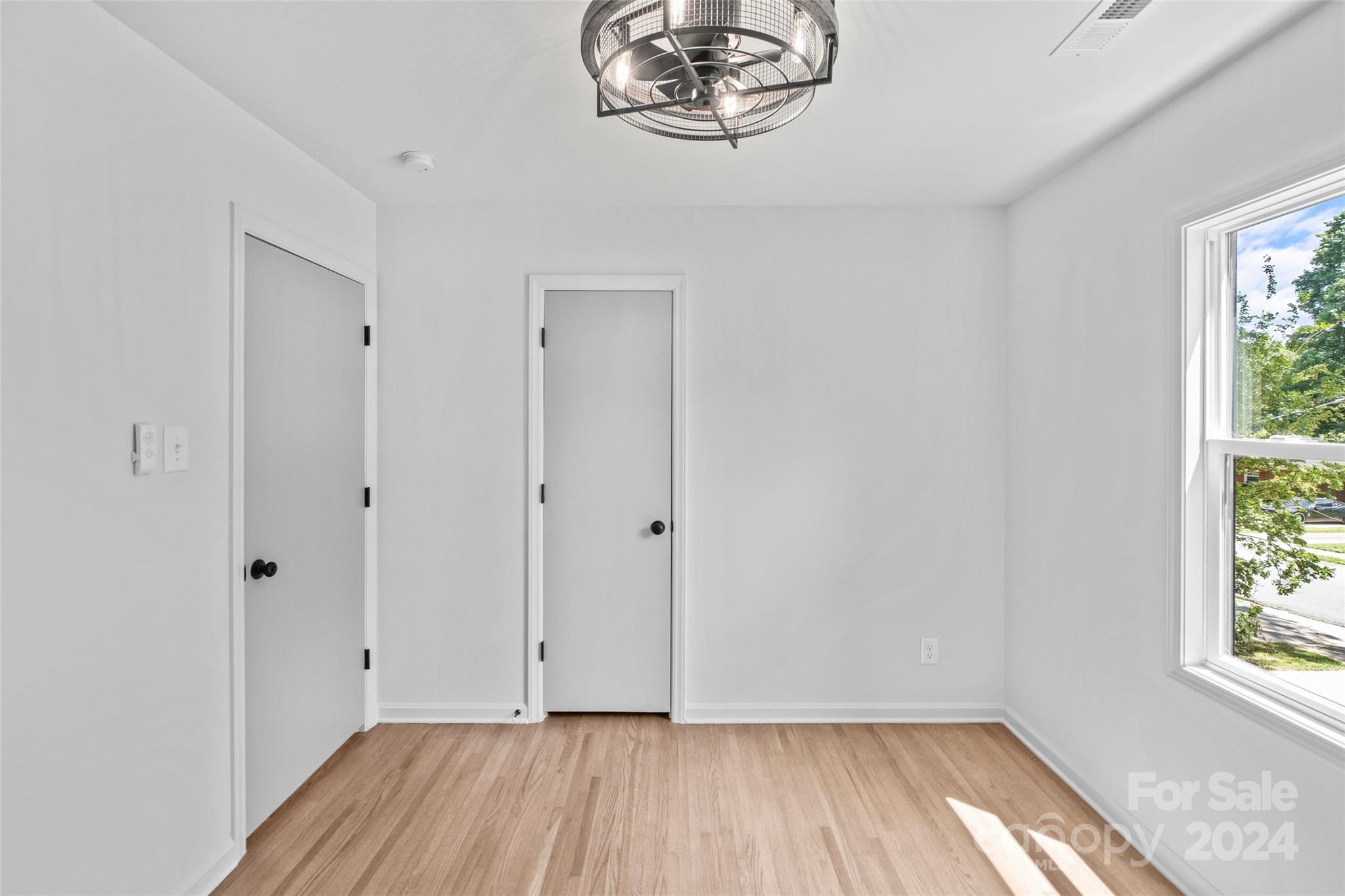 5807 Ruth Drive Charlotte, NC 28215 - Photo 22 of 41 a view of room with hardwood floor and window