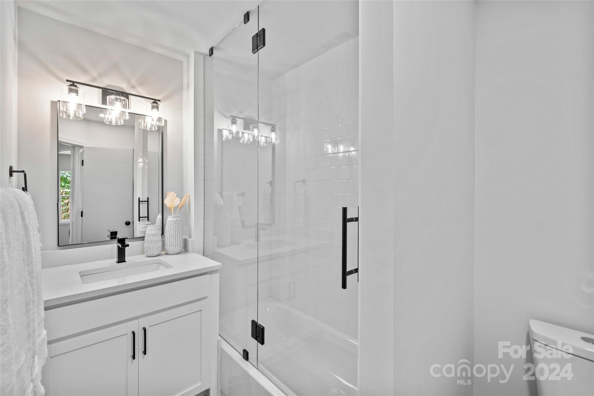 5807 Ruth Drive Charlotte, NC 28215 - Photo 24 of 41 a bathroom with a bathtub shower sink vanity and a mirror