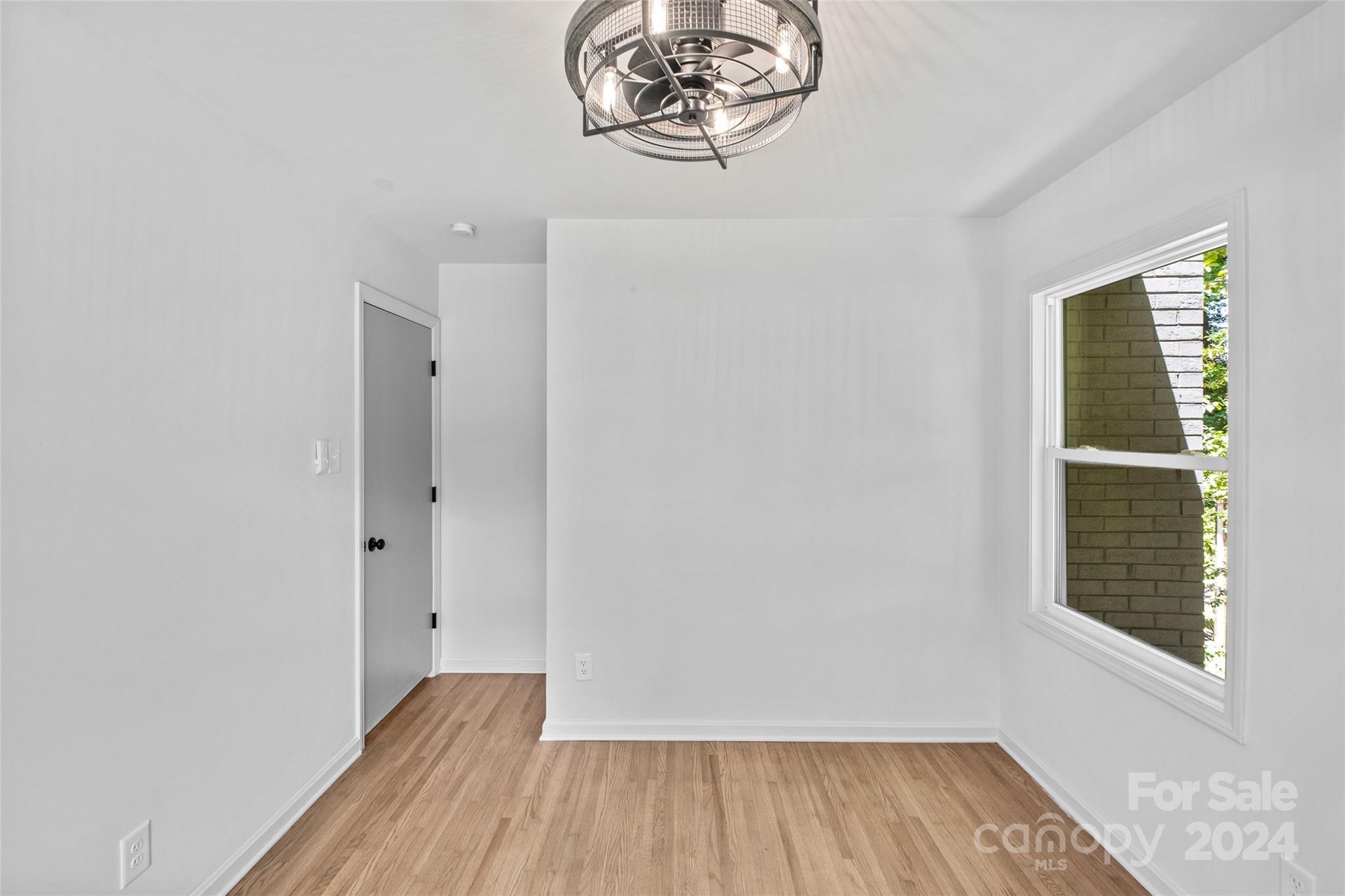 5807 Ruth Drive Charlotte, NC 28215 - Photo 26 of 41 an empty room with wooden floor and windows