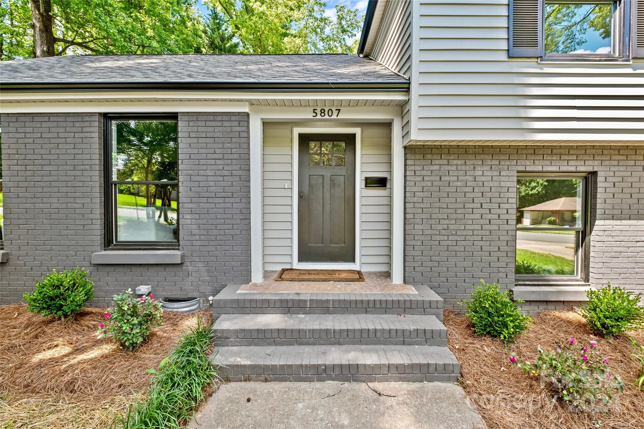 5807 Ruth Drive Charlotte, NC 28215 - Photo 3 of 41 a front view of a house with potted plants