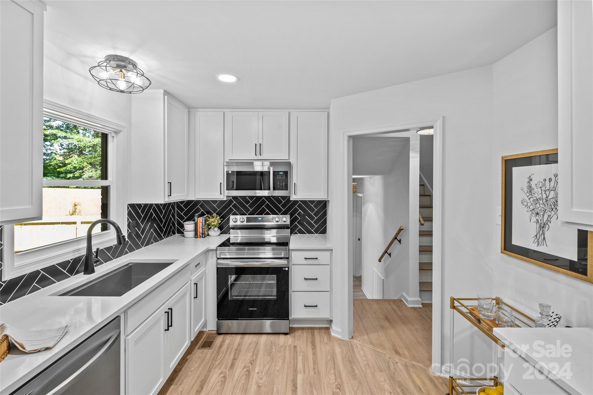 5807 Ruth Drive Charlotte, NC 28215 - Photo 10 of 41 a kitchen with stainless steel appliances a refrigerator sink and cabinets