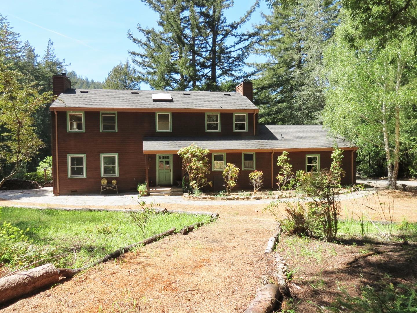 200 Wurr Road Loma Mar, CA 94021 - Photo 3 of 45 a front view of a house with a yard and trees