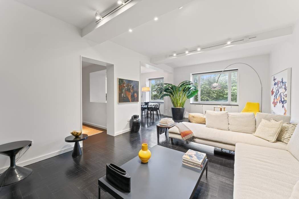 930 5th Avenue, Unit 7B Manhattan, NY 10021 - Photo 1 of 15 a living room with furniture and a wooden floor
