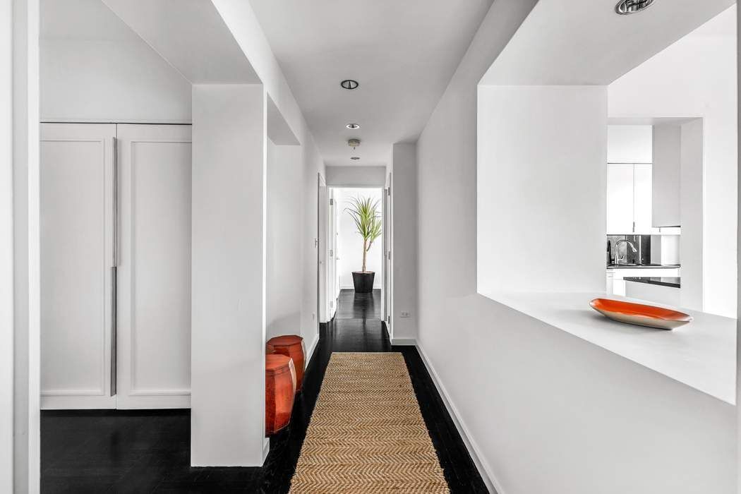 930 5th Avenue, Unit 7B Manhattan, NY 10021 - Photo 5 of 15 a view of hallway with chandelier