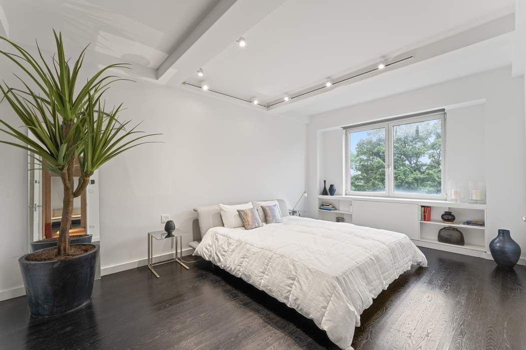 930 5th Avenue, Unit 7B Manhattan, NY 10021 - Photo 6 of 15 a bedroom with a large bed and a window