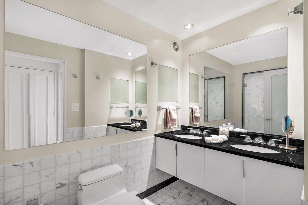 930 5th Avenue, Unit 7B Manhattan, NY 10021 - Photo 7 of 15 a kitchen with sink and view of living room