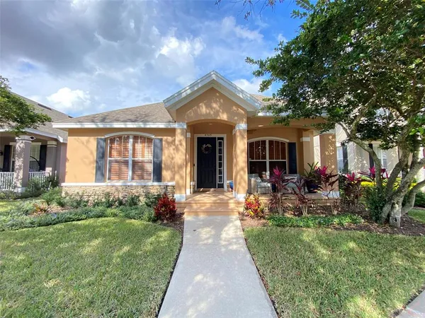 a front view of a house with yard and green space