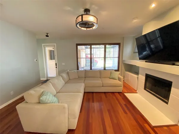 a living room with furniture flat screen tv and a fireplace