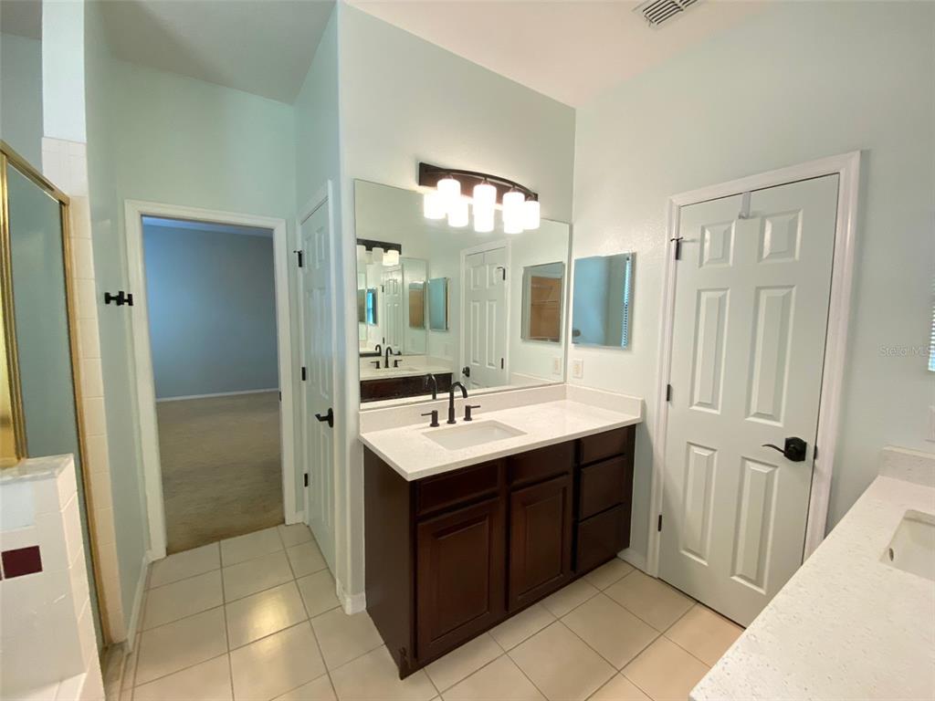 8763 Coco Plum Place Orlando, FL 32827 - Photo 19 of 26 a bathroom with a sink and a mirror