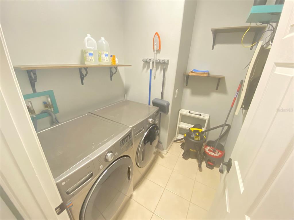 8763 Coco Plum Place Orlando, FL 32827 - Photo 24 of 26 a utility room with dryer and washer