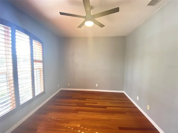 wooden floor in an empty room with a window