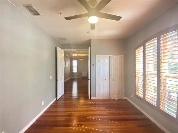a view of a livingroom with wooden floor and a ceiling fan