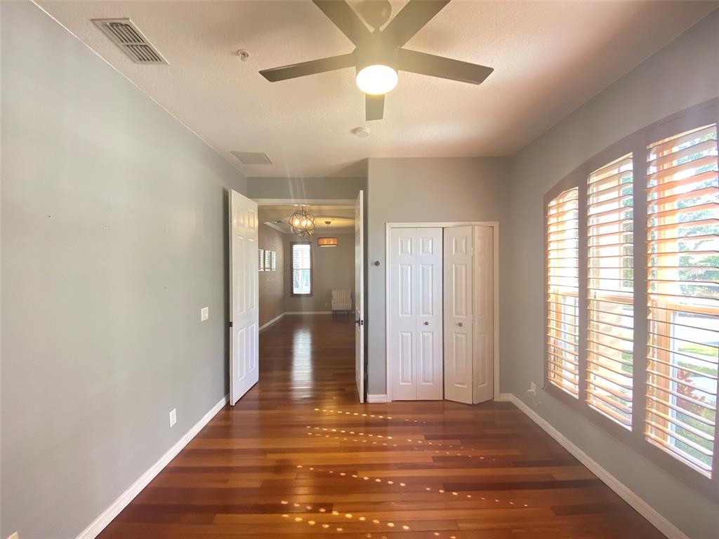 8763 Coco Plum Place Orlando, FL 32827 - Photo 6 of 26 a view of a livingroom with wooden floor and a ceiling fan