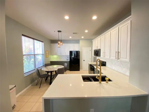 a kitchen with refrigerator and window