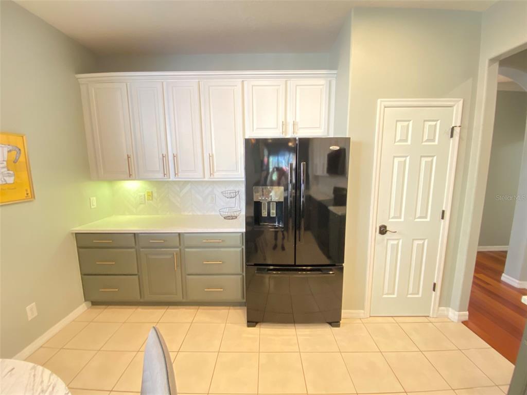 8763 Coco Plum Place Orlando, FL 32827 - Photo 9 of 26 a kitchen with refrigerator and window