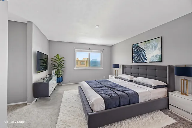 a bedroom with a large bed and a couch