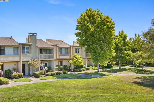 a front view of a house with swimming pool having outdoor seating