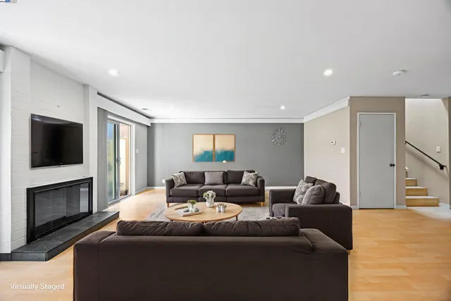 a living room with furniture wooden floor and a flat screen tv