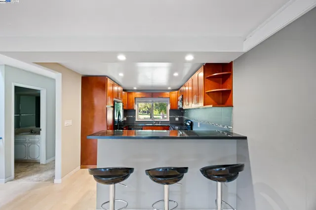 a kitchen with stainless steel appliances a sink and cabinets