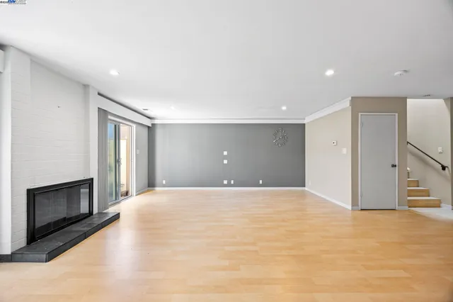 a view of an empty room with a fireplace