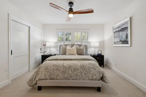 a spacious bedroom with a bed and a chandelier