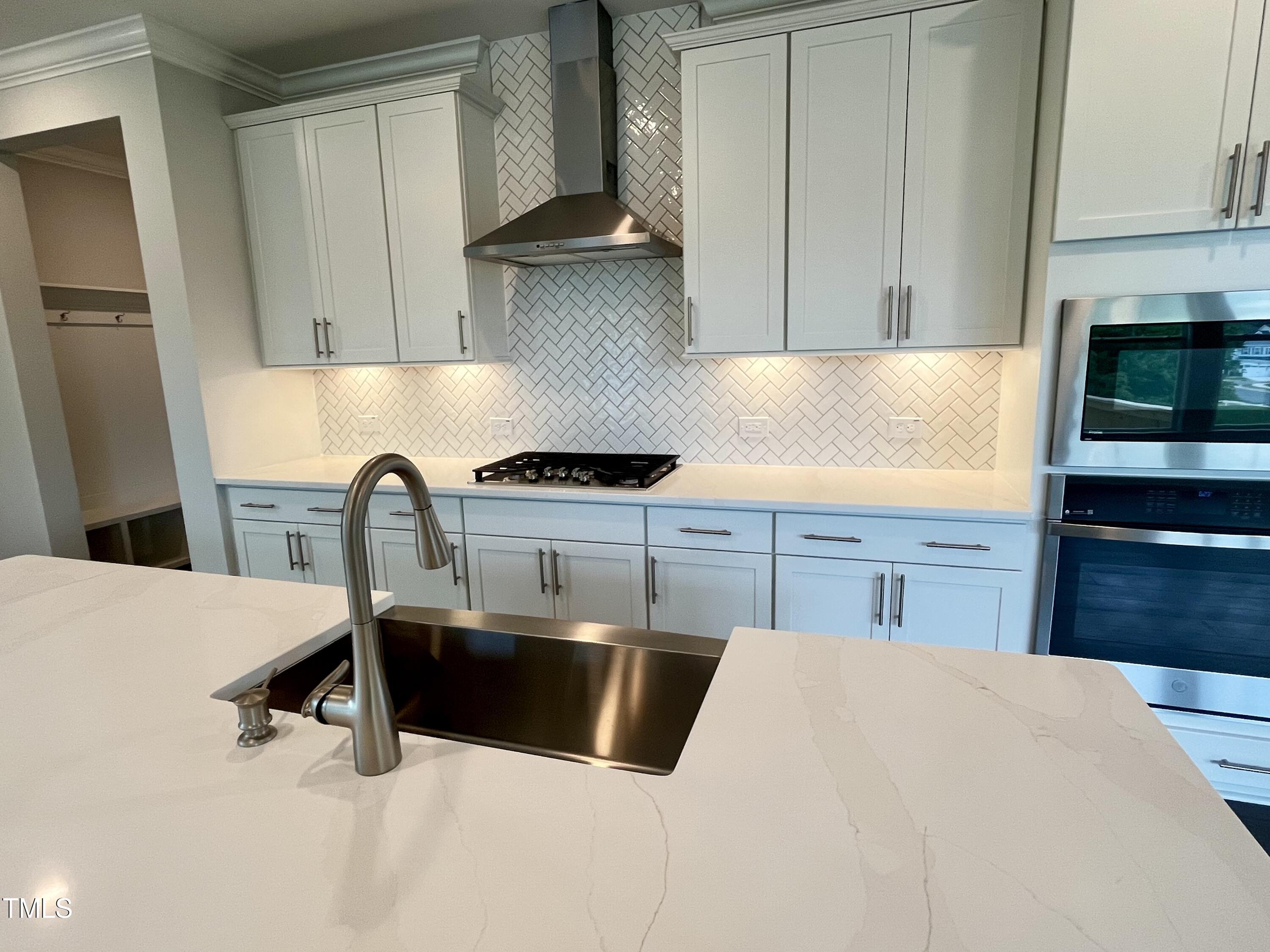 961 Jasper Mine Trail Raleigh, NC 27610 - Photo 6 of 38 a kitchen with stainless steel appliances a sink a stove and a refrigerator