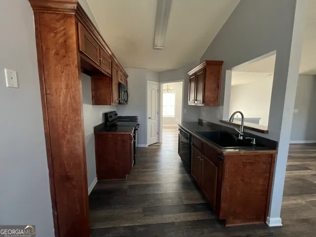 a kitchen with stainless steel appliances granite countertop a stove and a sink