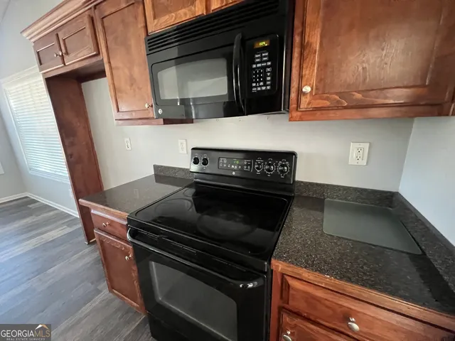 a kitchen with wooden cabinets and a stove top oven